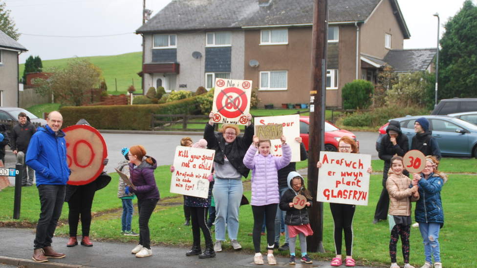 Villagers campaigning on side of road