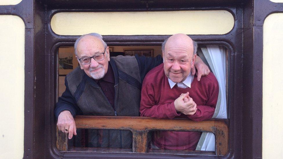 Father and son Stephen and John West leaning out of the railway carriage window