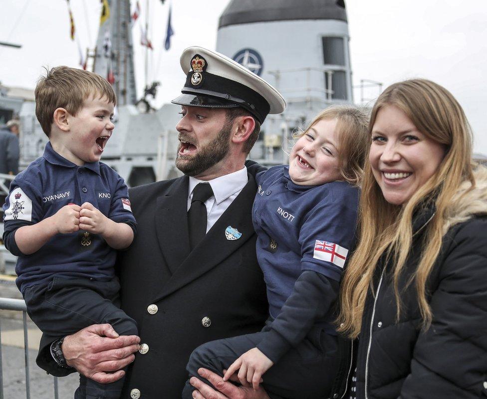 A sailor greets his family