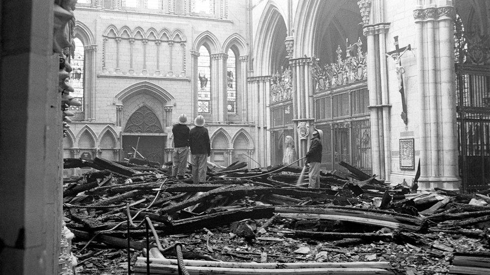 Firefighters assess the damage