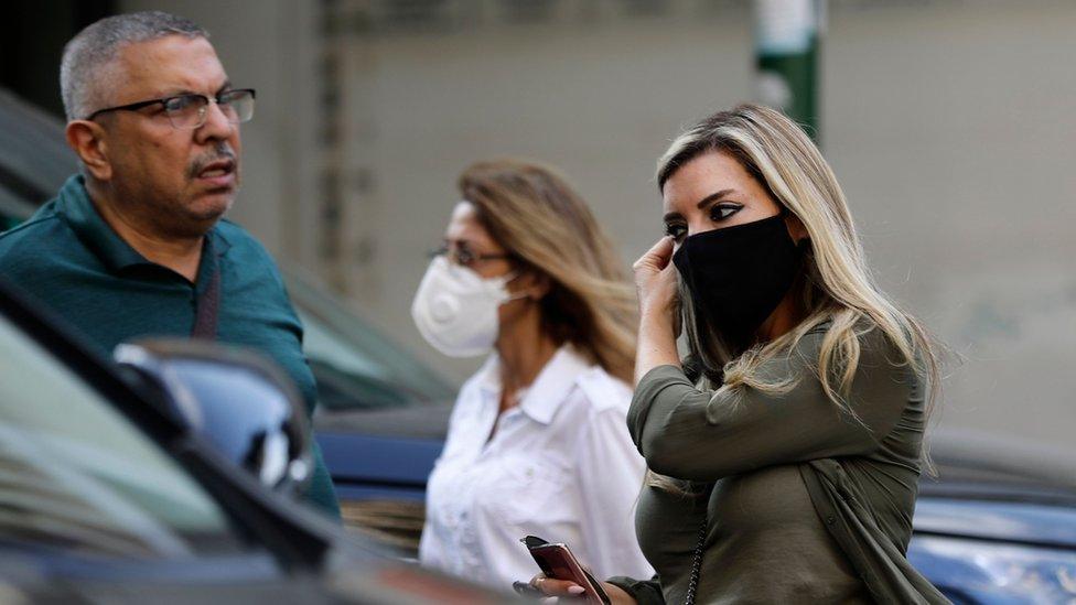 People wearing face masks walk along a street in Beirut, Lebanon (2 November 2020)