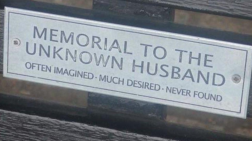 Bench dedication: "Memorial to the unknown husband. Often imagined. Much desired. Never found."