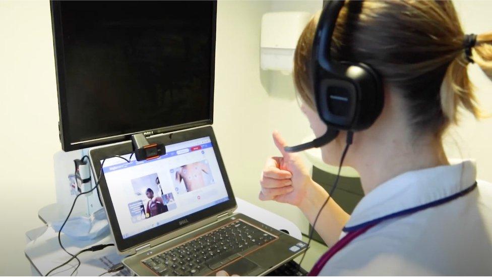 A member of hospital staff carries out a remote consultation