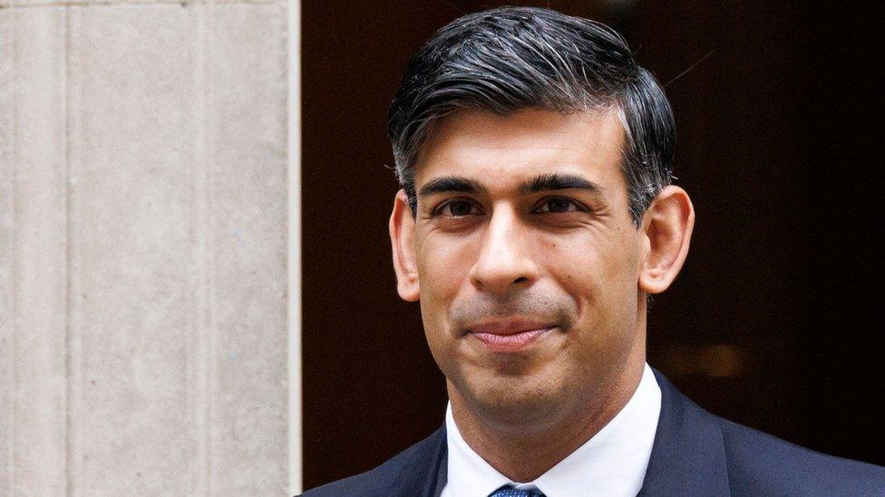 British Prime Minister Rishi Sunak departs his official residence, 10 Downing Street, to attend the Prime Minister's Questions at the Parliament in London, Britain, 17 January 2024 - he appears to be smiling and is wearing a blue tie