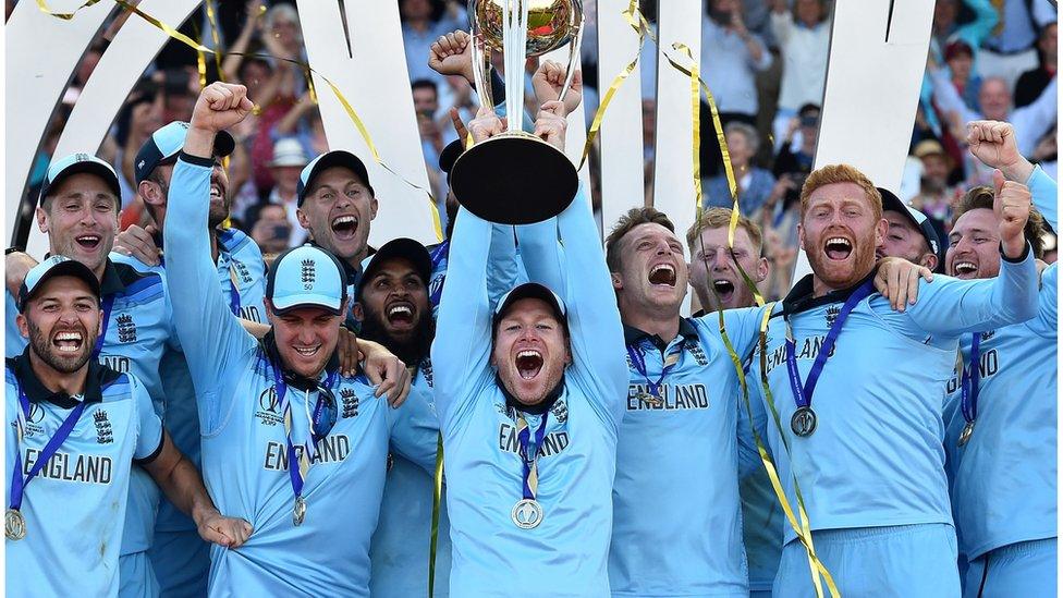 Englands captain Eoin Morgan lifts the World Cup trophy as England players celebrate their win after the 2019 Cricket World Cup