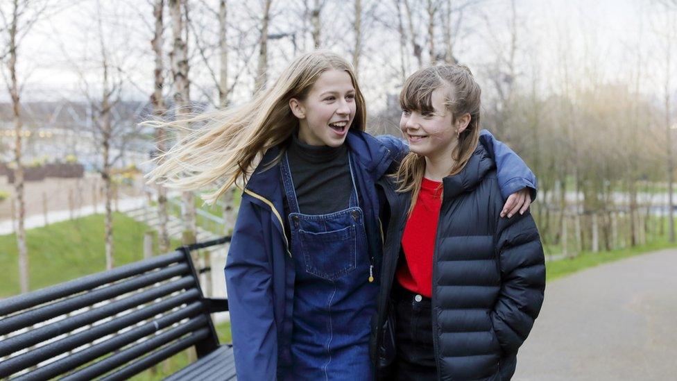 two girls walking outside