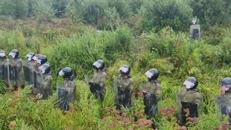 A video showing Belarusian officers in riot gear near the Belarus-Lithuania border