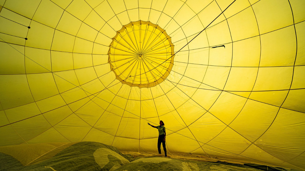 Inside a yellow hot air balloon canopy