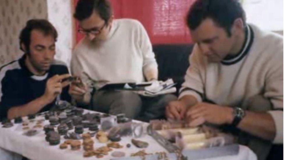 Robert Sténuit and crew members survey their findings from the Girona dive