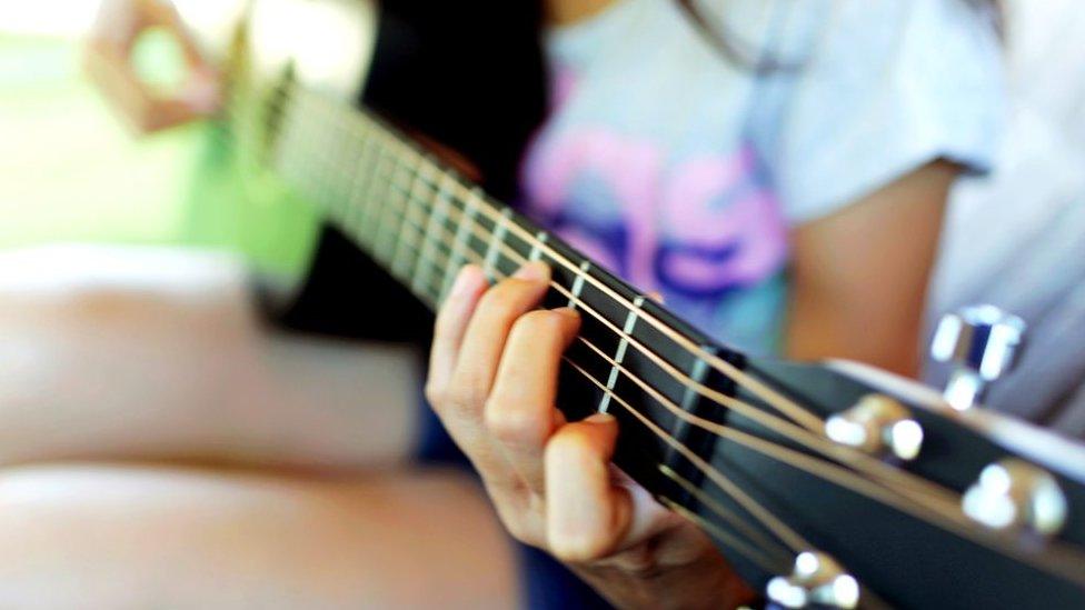 Child playing guitar