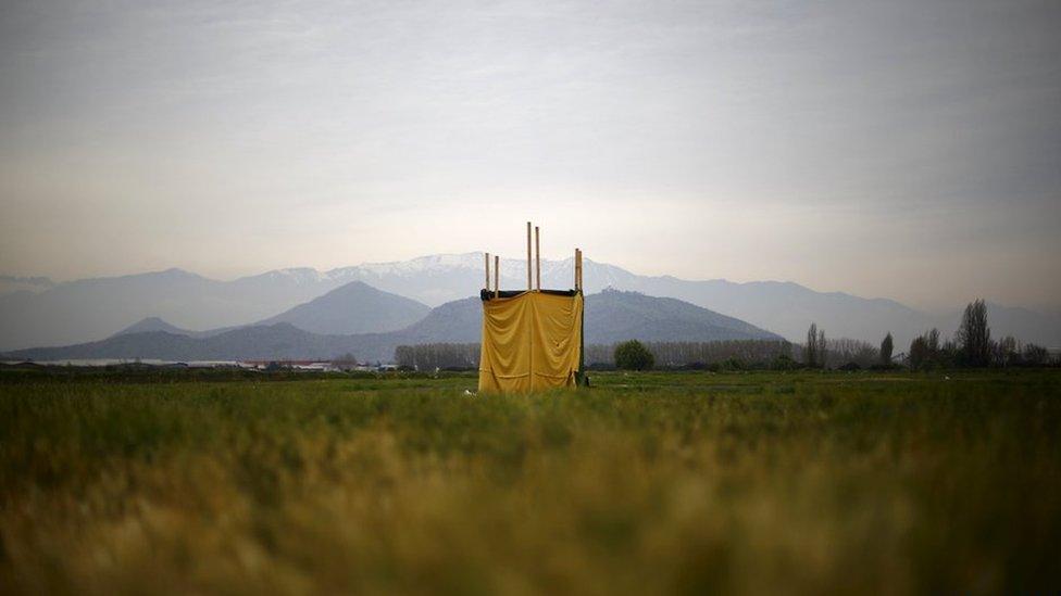 Toilet in the middle of an empty field on the outskirts of Santiago, Chile