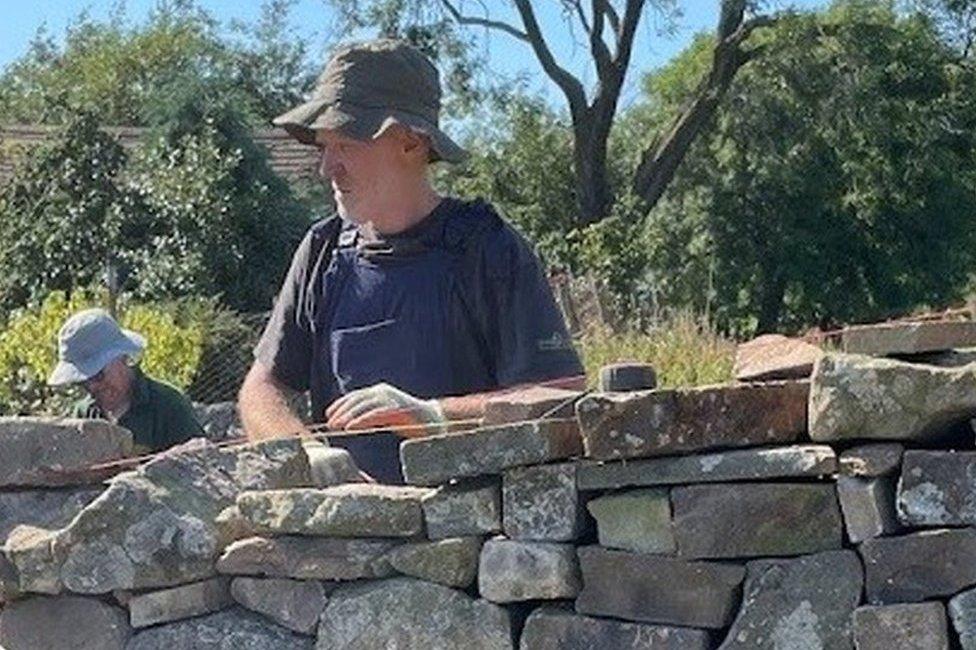 Paul Foster building a dry stone wall