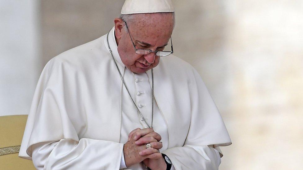 Pope Francis prays during his weekly general audience in St Peter's Square on 14 October 2015