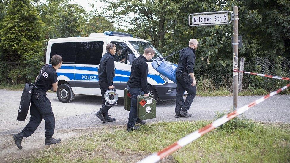 Investigators arrive as officers search a garden plot in Hanover, northern Germany, 29 July 2020.