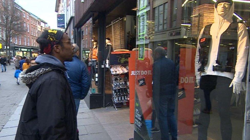 Damien Henry looking at the utility jacket in Footasylum's window