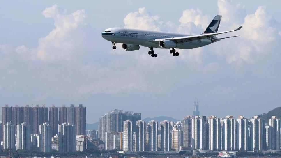 Cathay Pacific jet over city