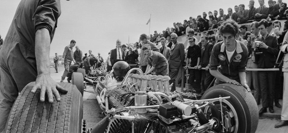 Racing driver Jim Clark (1936 - 1968) during a pit stop before a practice lap at Silverstone, 14th July 1967.