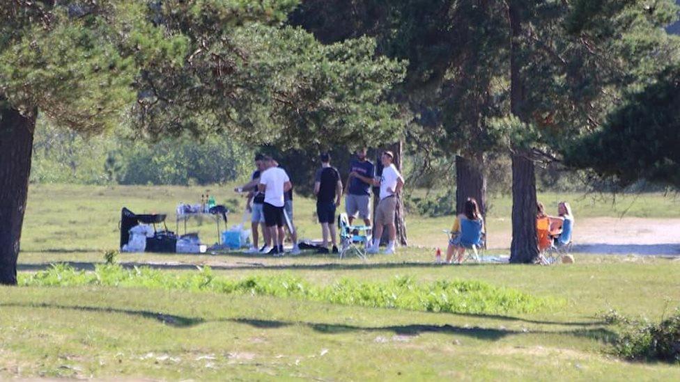 Visitors having barbecue