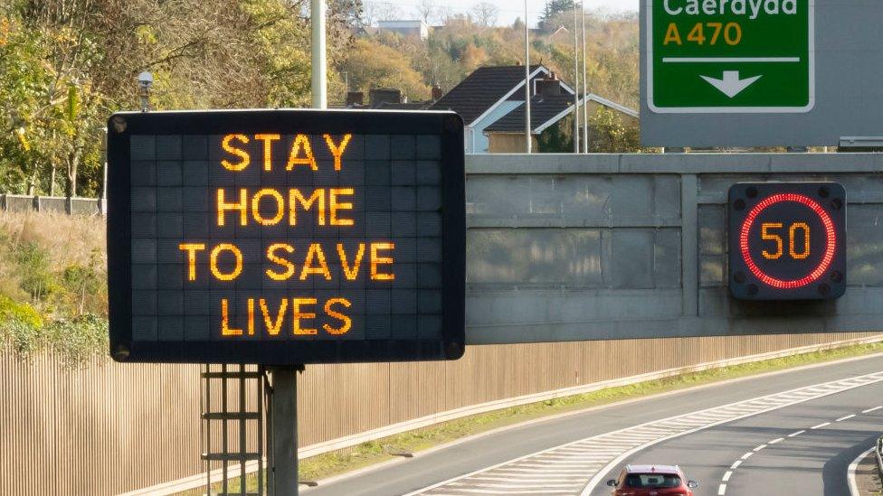 Stay home to save lives sign on motorway