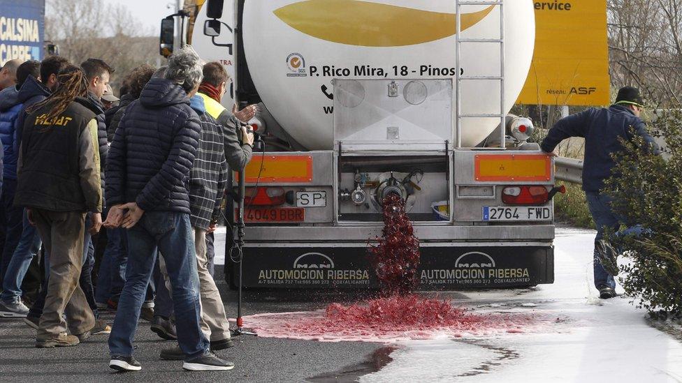 Wine flows from the tap of a Spanish lorry