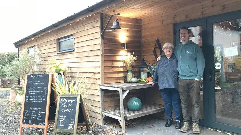 Chris and Bev Haywood standing outside their shop which sells wine