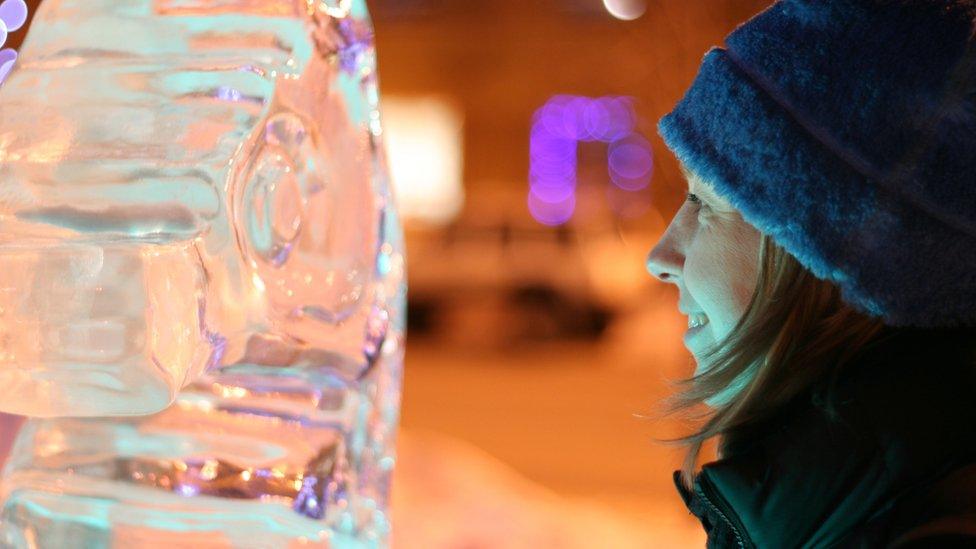 woman staring at ice sculpture