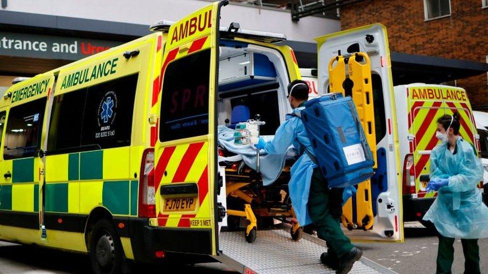 A patient is taken from an ambulance at Guy's Hospital in central London on Tuesday