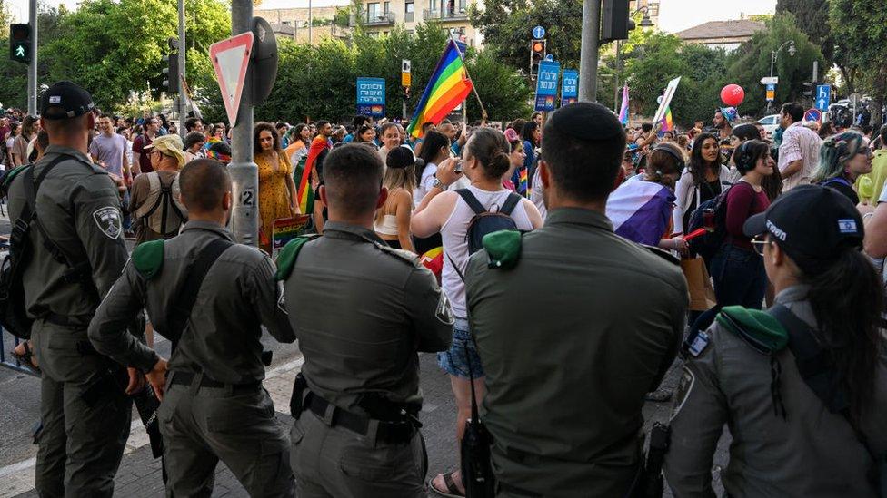 Israeli police line the route of the march