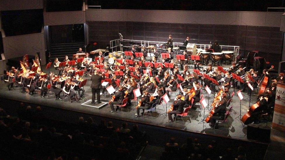 Large orchestra made up of young players on stage at the Derngate theatre