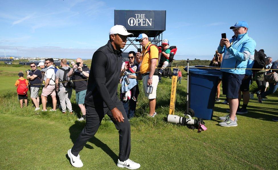 Tiger Woods walks past spectators at Royal Portrush during his first practice round for the Open