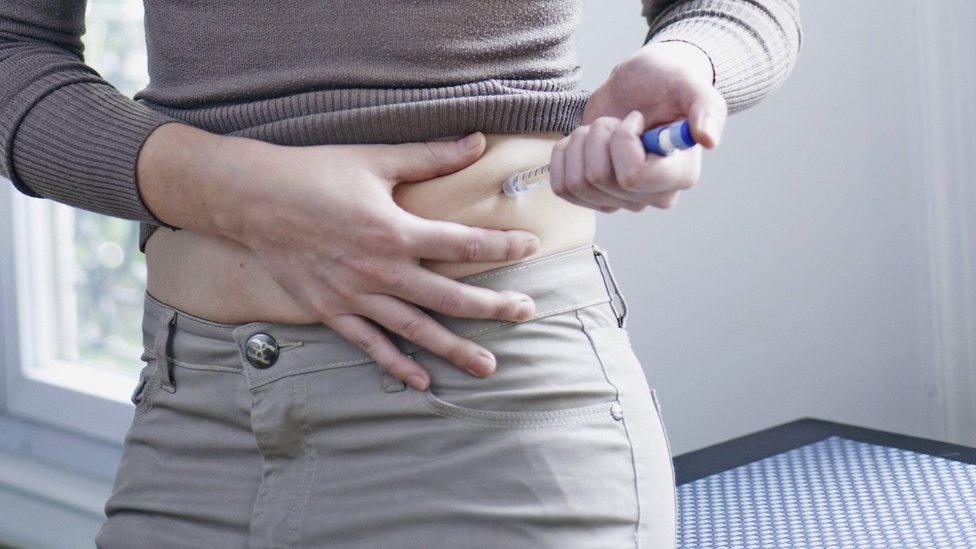 Woman having insulin injection