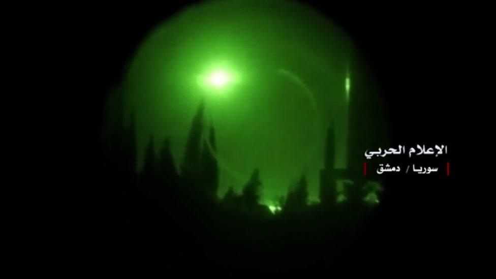 n explosion in the sky over Damascus seen through a night-vision device