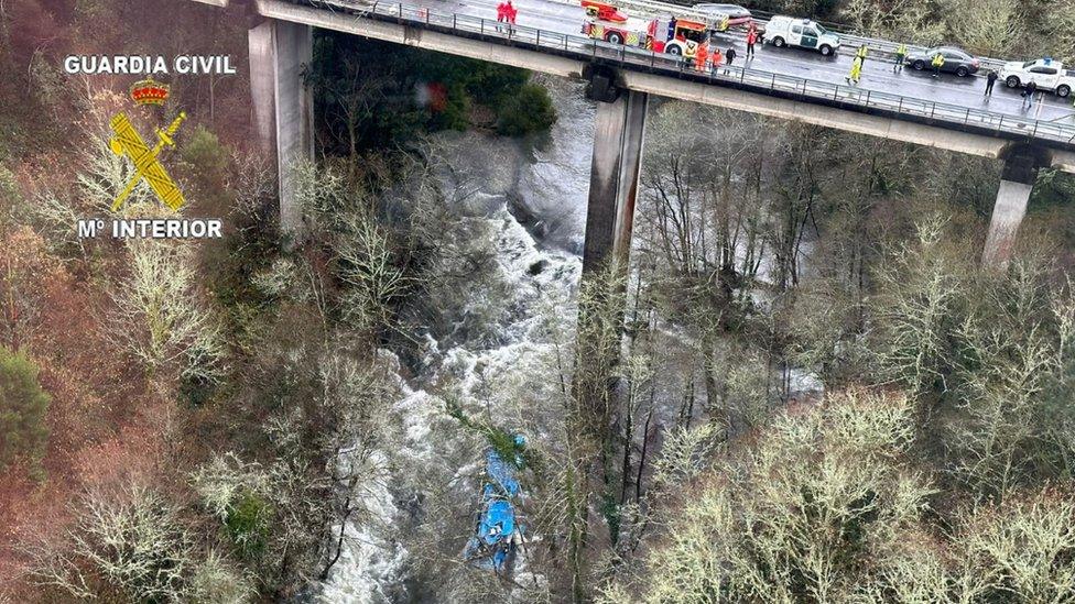 Spain's emergency services look from a bridge at the bus wreckage in the Lerez river, north-western Spain. Photo: 25 December 2022