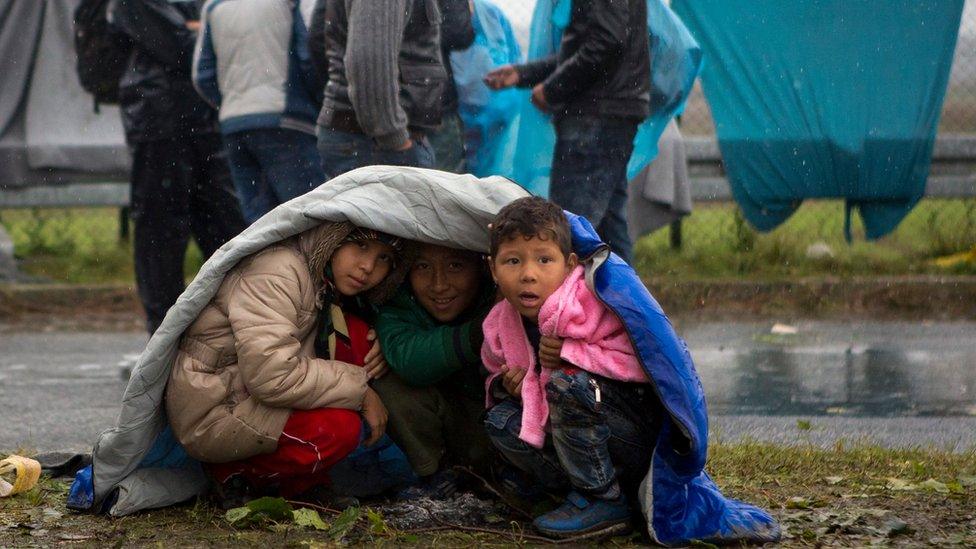 Children take shelter from the rain in Sredisce ob Dravi, a border crossing between Croatia and Slovenia (Oct. 19, 2015)