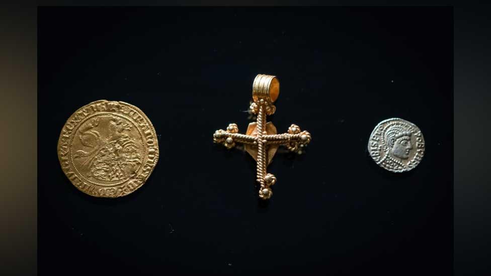 Gold leopard coin, gold cross and gold shilling