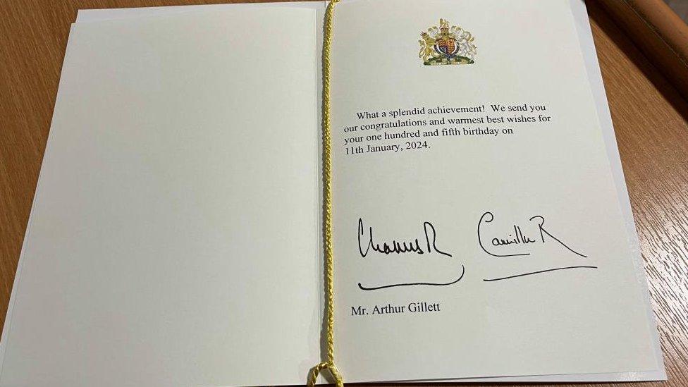 Inside of a birthday card signed by Charles III and Queen Camilla