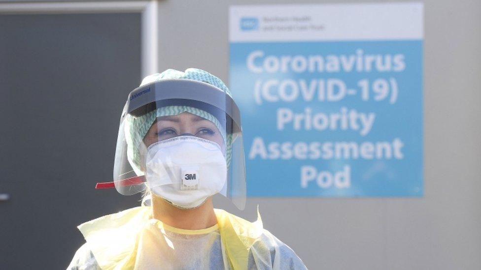 A healthcare worker wearing PPE at a hospital