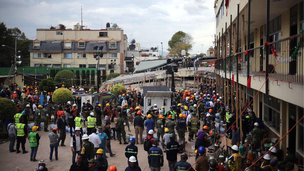 Rescue teams gather to help search for survivors at the Enrique Rébsamen primary school, Mexico City, 20 September 2017