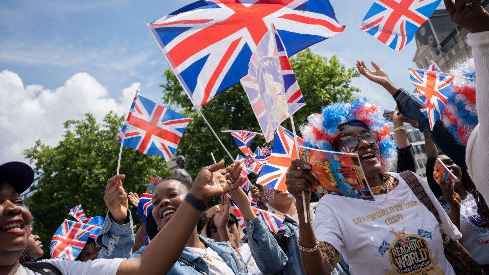 Londoners wave flags during Trooping the Colour on Thursday 2 June, 2022