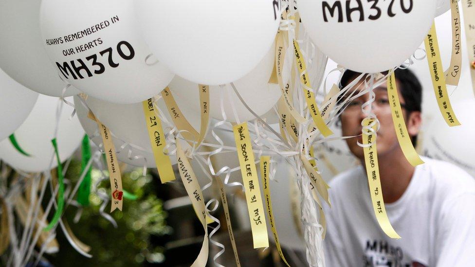 White balloons tagged with the names of everyone aboard Malaysia Airlines Flight 370 are seen before being released during a commemorative event in Kuala Lumpur