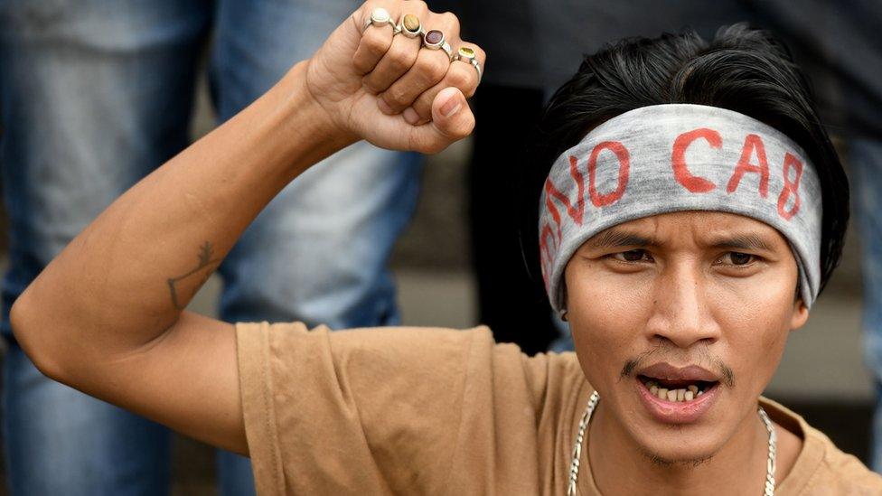 A protester in Bangalore wearing a headband with "NO CAB" written on it