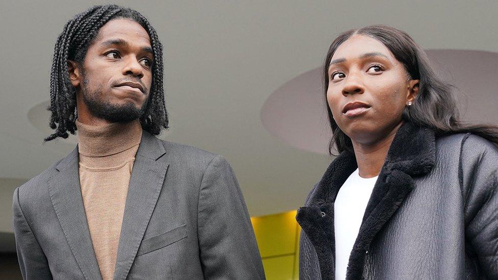 Athletes Ricardo Dos Santos and Bianca Williams outside Palestra House in central London. They are both wearing jackets and looking off-camera