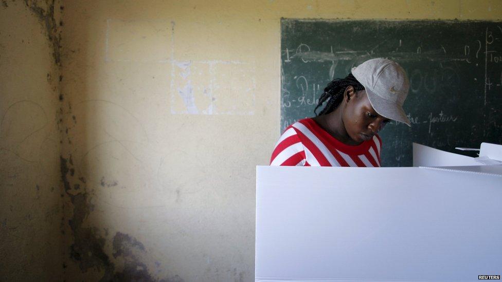 A woman votes in Haiti's parliamentary elections