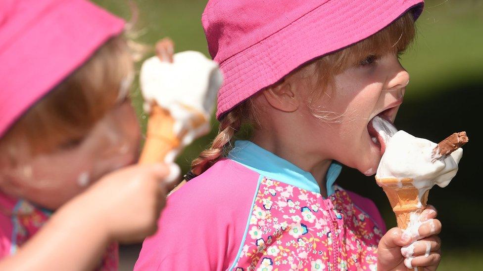 Twins Isabelle (left) and Charlotte Abercrombie, 3, enjoying ice creams in Stratford-upon-Avon