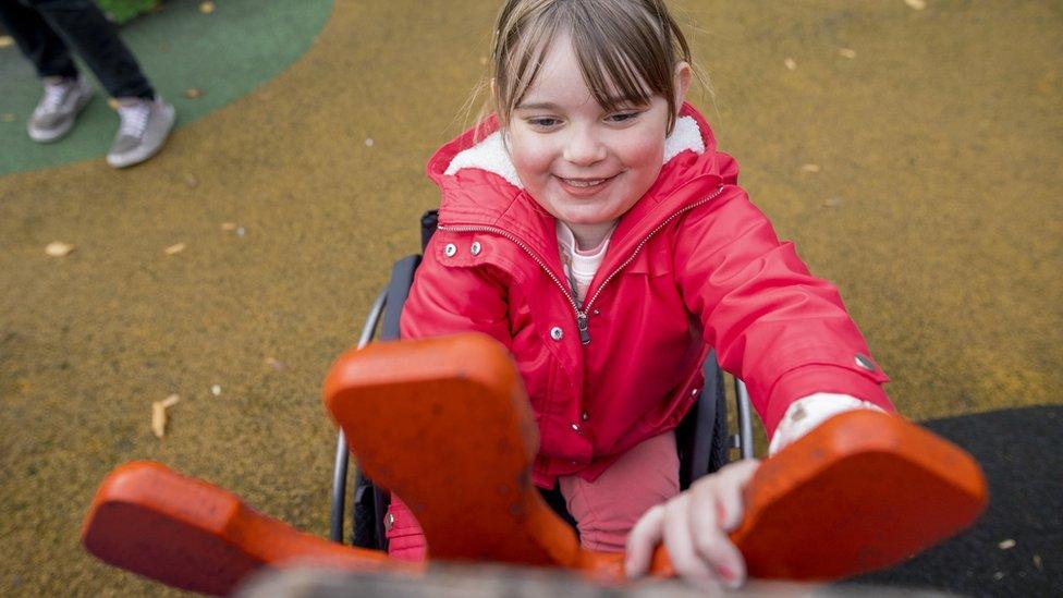 Girl playing with an interactive game at a playground