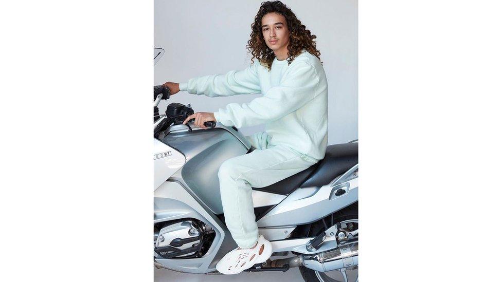 Man on motorcycle wearing new kanye west trainer