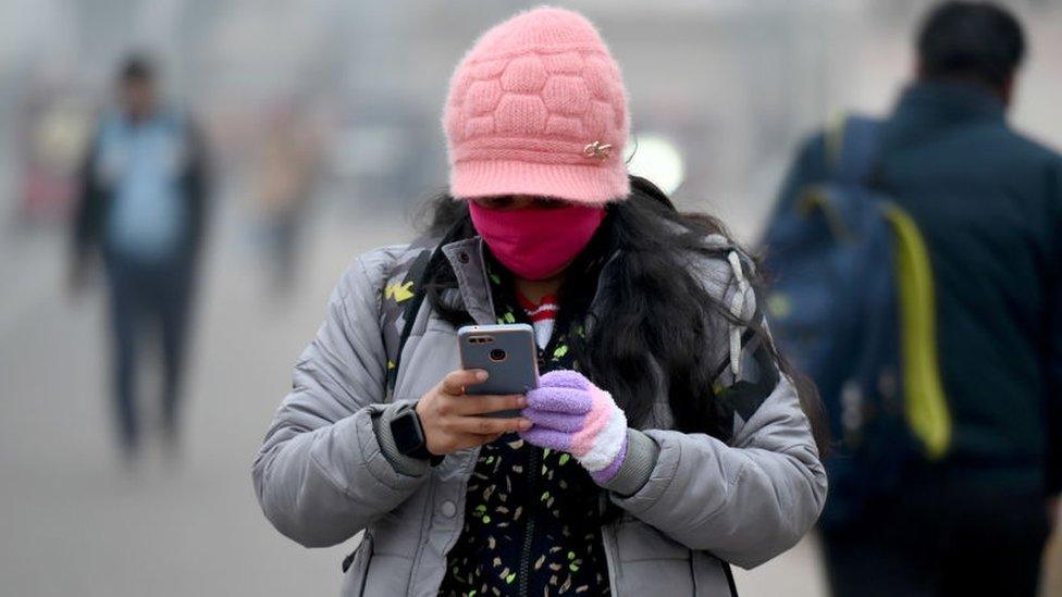 Commuters wearing warm cloths out on a smoggy and cold morning, on January 6, 2023 in Noida, India.