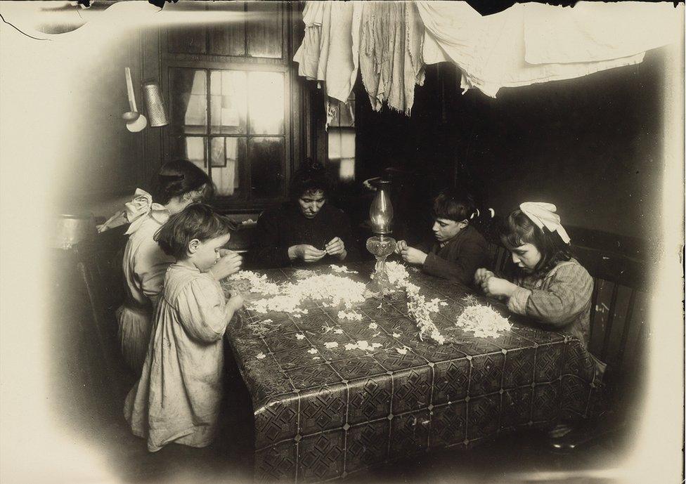 Children making artificial flowers.