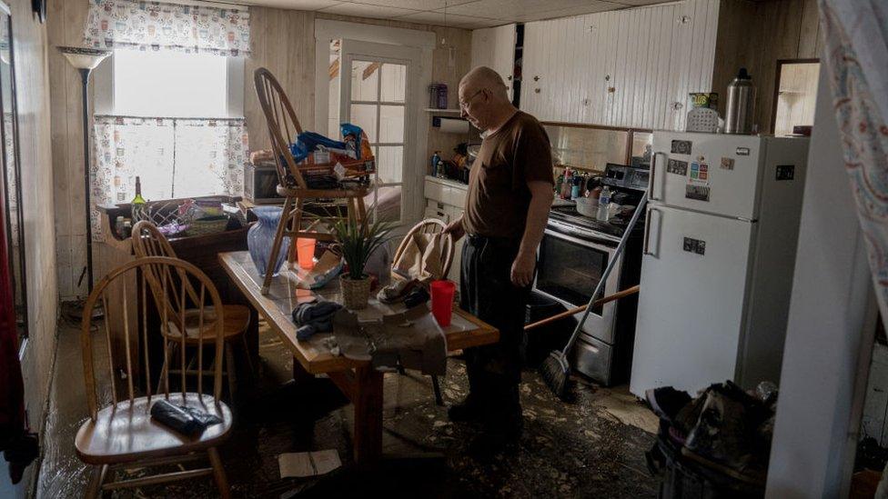 Gordon George, of Barre, Vermont, worked with his daughter, Danielle Palmer, of Washington, to survey the damage to his home