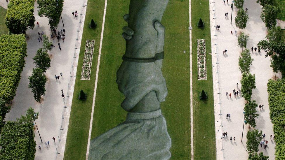 This aerial picture taken on June 13, 2019 shows a 600 meters long installation by French land artist SAYPE entitled "Beyong Walls"